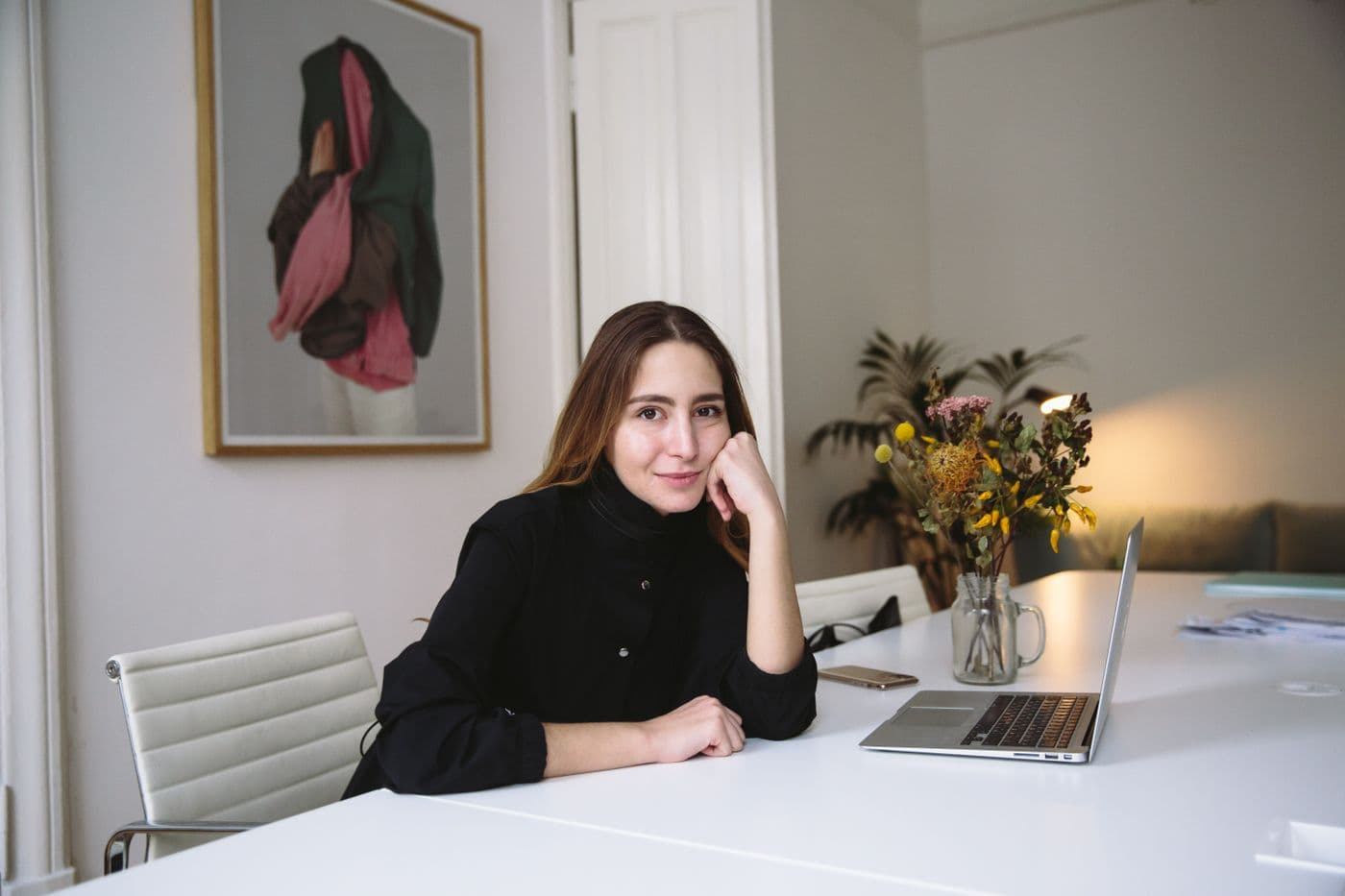 Marisol Reyes, a licensed insurance agent, sitting at her desk and smiling toward the camera.